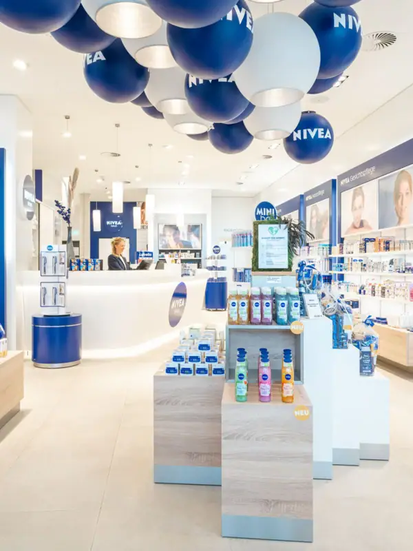 NIVEA Shop Ein Geschäft mit blauen und weißen Luftballons an der Decke.