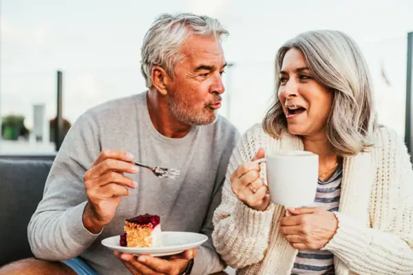 Kaffeepause Ein Mann und eine Frau essen Kuchen.