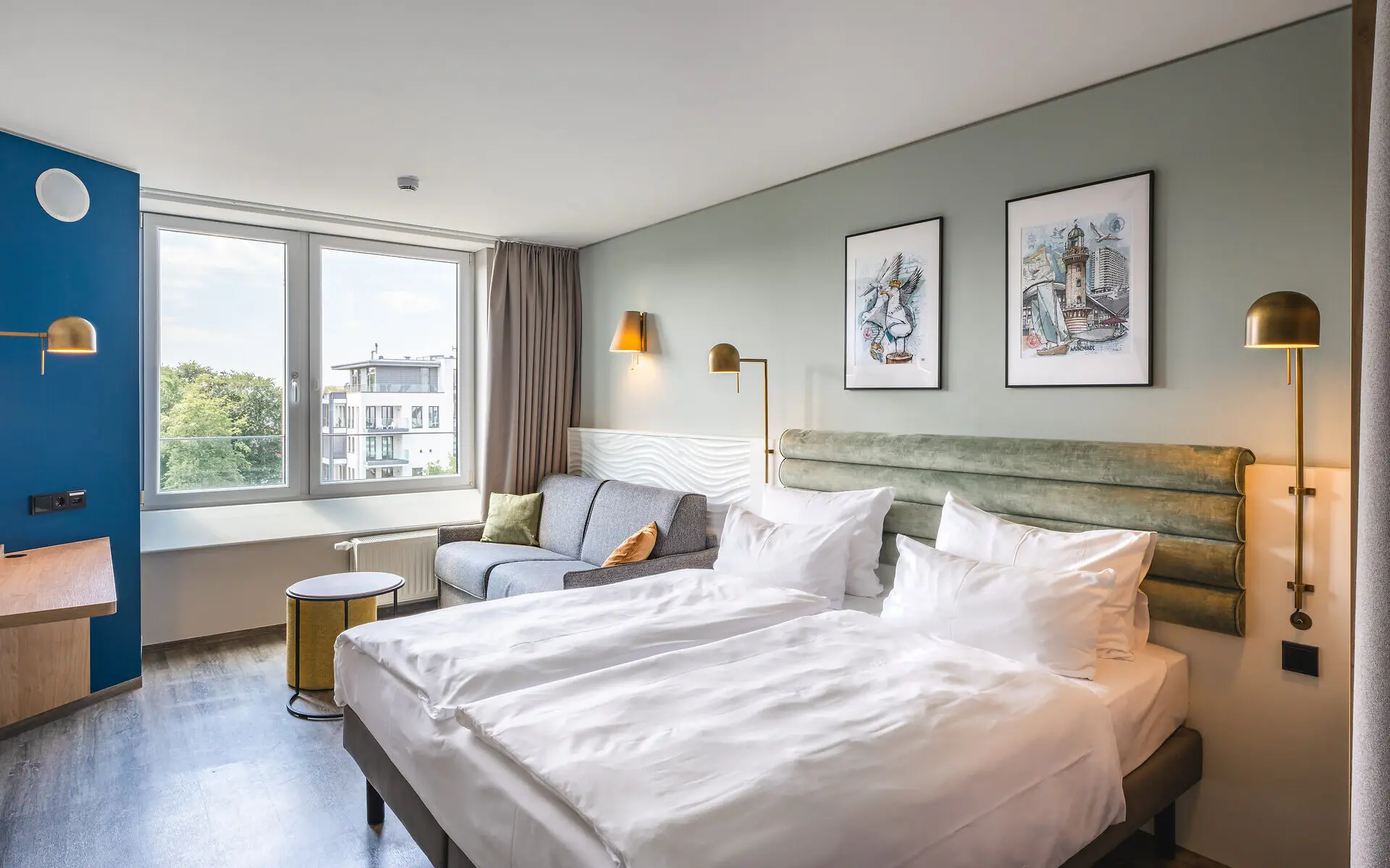 Doppelzimmer Komfort Zwei Betten und eine Couch in einem Zimmer.