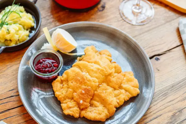 Schnitzel in der aja Bar Ruhpolding Ein Teller mit Essen auf einem Tisch.