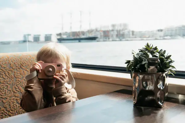 Schifffahrt Ein Kind hält eine Kamera.