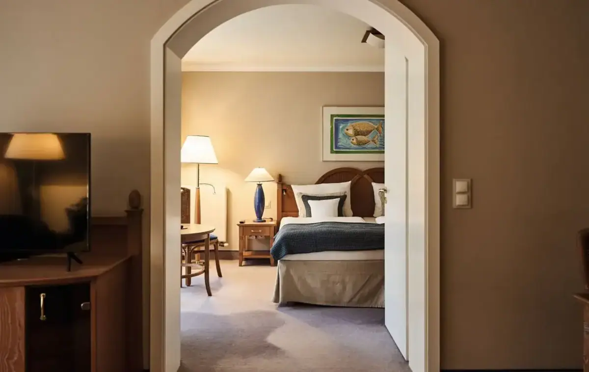 Senior-Suite Schlafzimmer mit Bett, Nachttisch und Lampe.