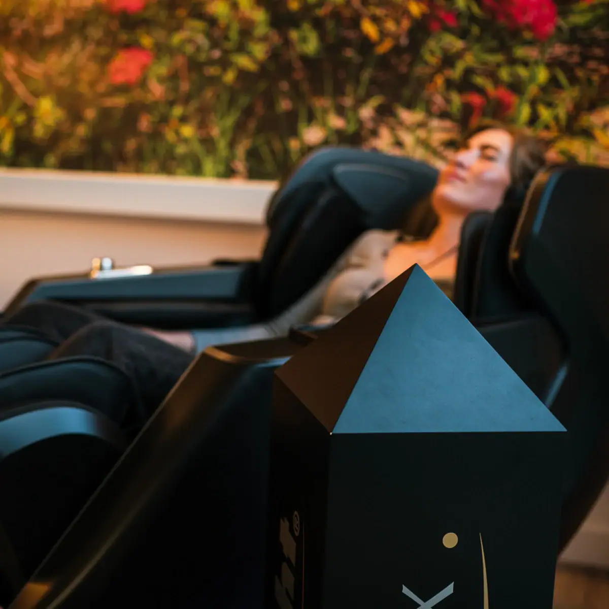 Massageliege Eine Frau liegt in einem Massagestuhl.