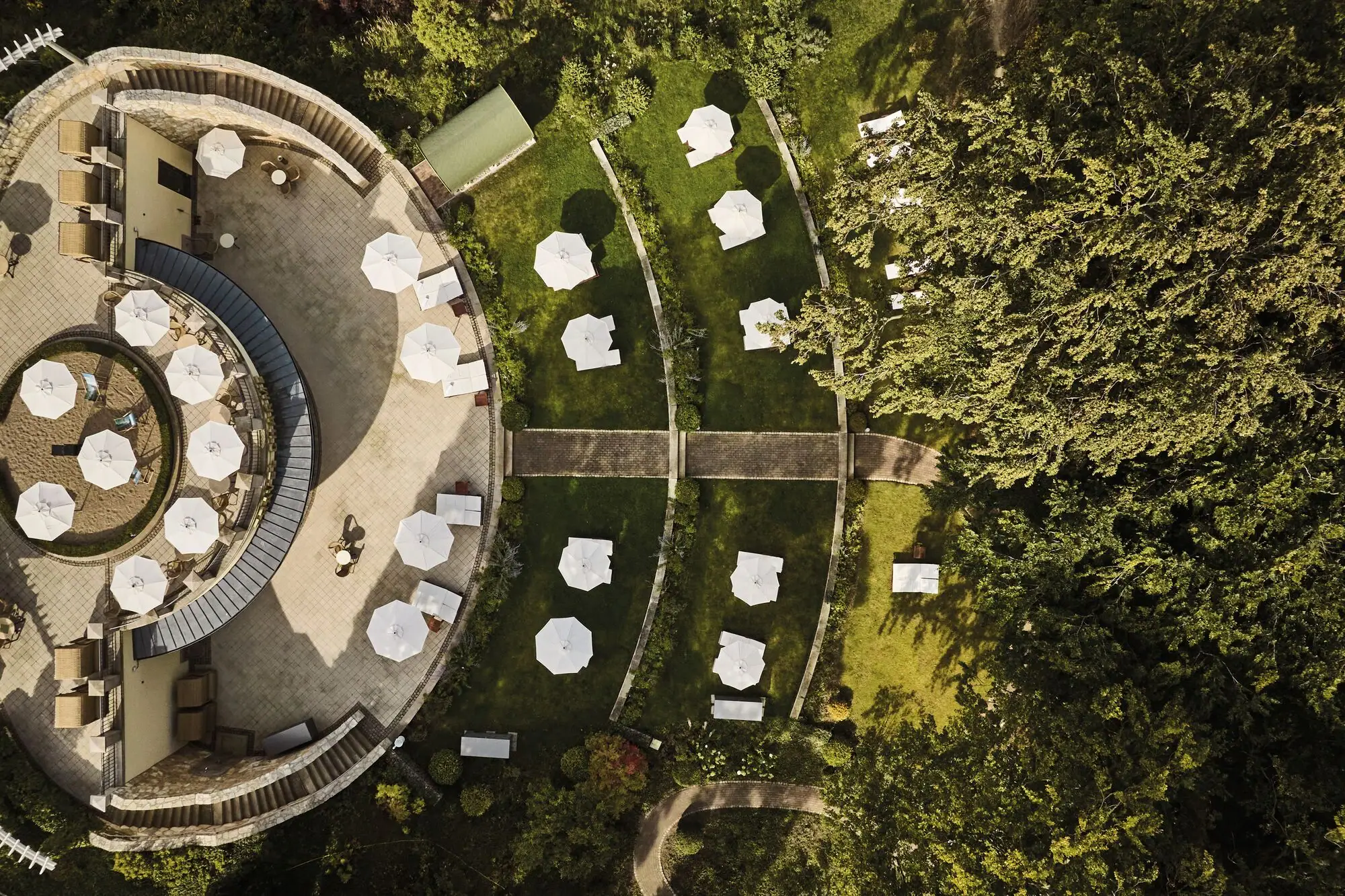 Liegewiese Luftaufnahme eines Gebäudes mit Sonnenschirmen und Grasflächen