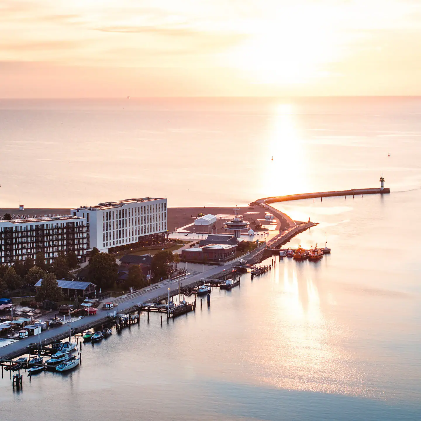Ein Gewässer mit einem Pier und Gebäuden im Hintergrund.