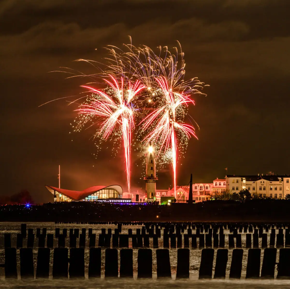 Silvester im aja Warnemünde Feuerwerk am Nachthimmel über der Stadt.